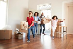 Defining Dreams and Goals At Work and In Life - family moving into newly purchased home